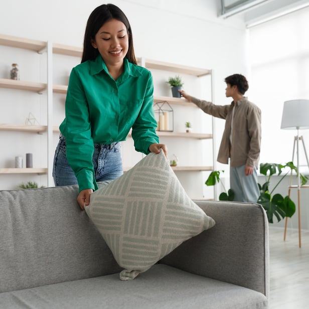 A young couple is tidying up their new home